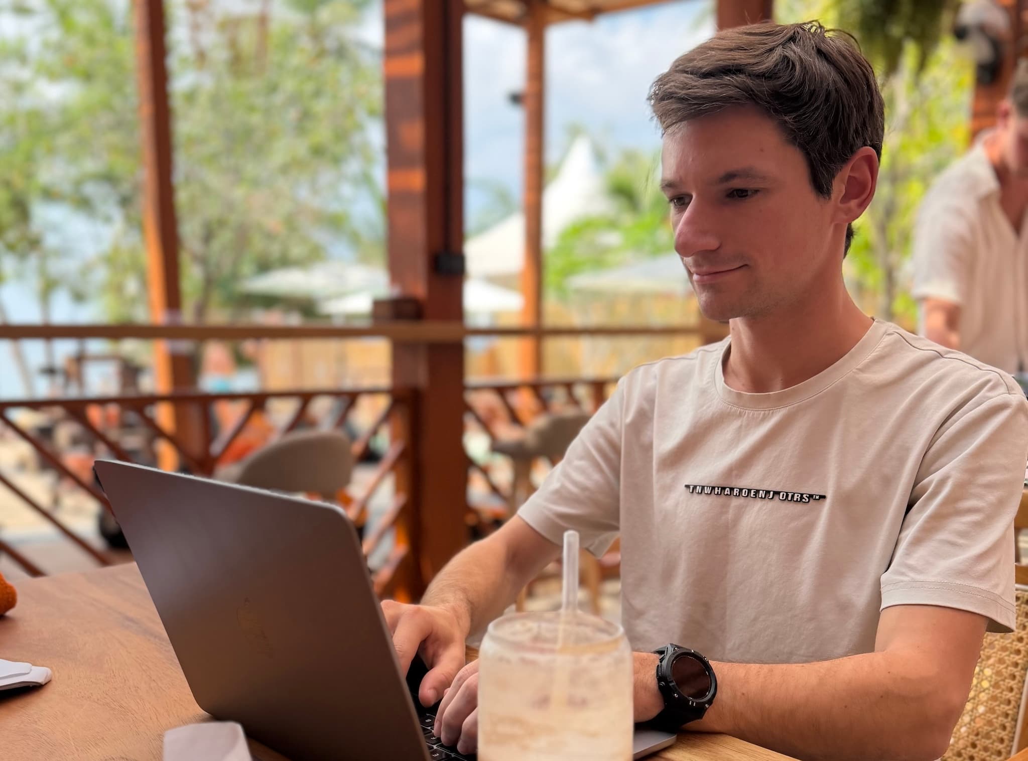 Matthew Fisher working at a café in Southeast Asia